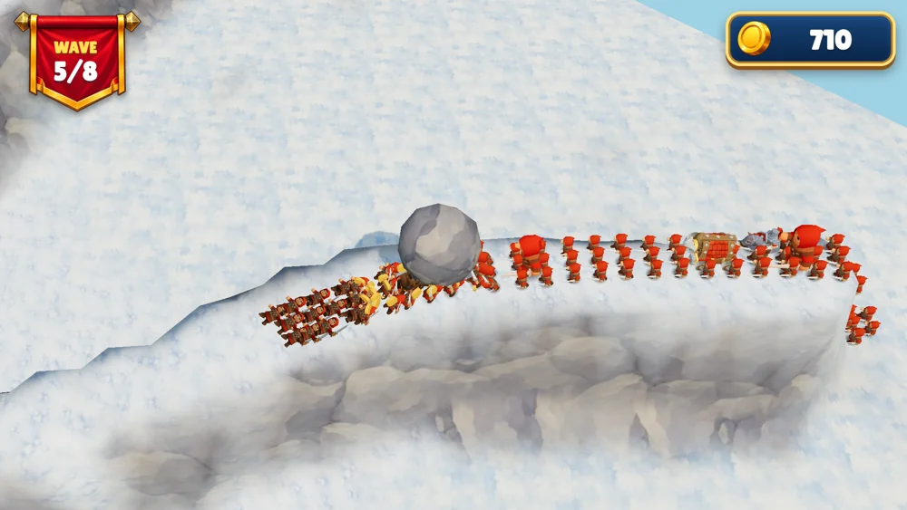 A giant boulder rolls through enemy soldiers on a snowy path